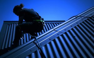 Man repairing a house roof